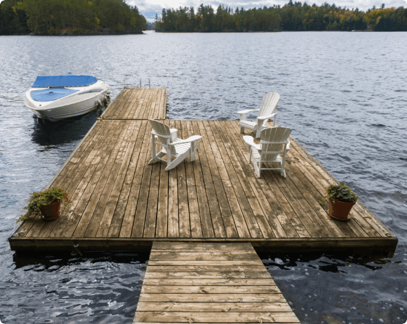 A boat dock with chairs on it.