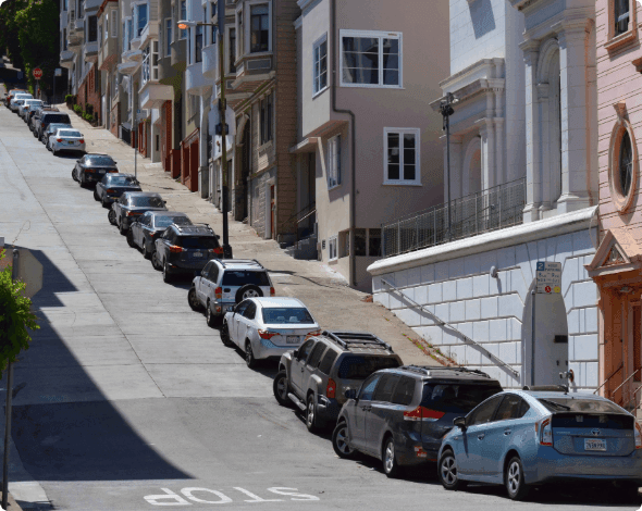Cars parked uphill.