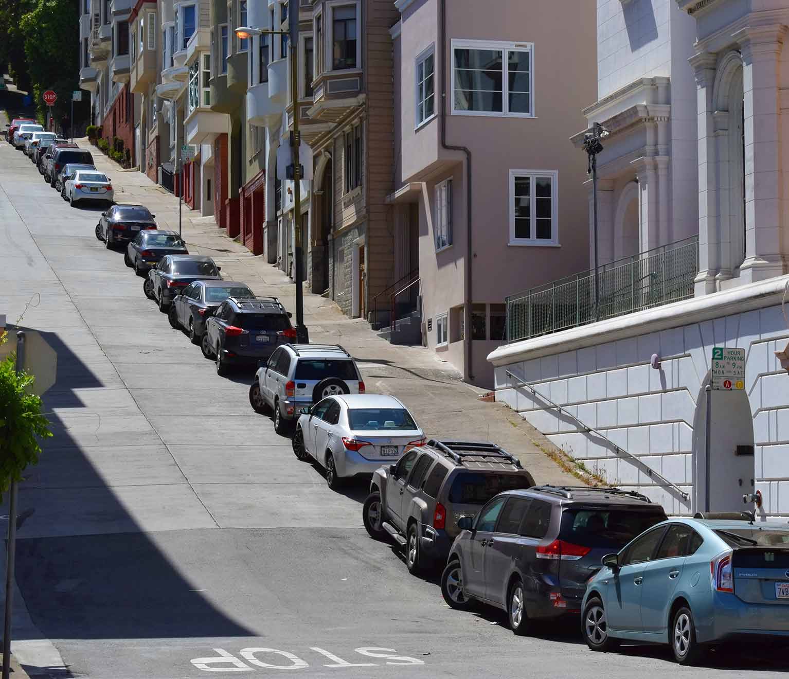 Cars parking uphill on a steep hill