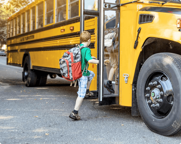 child stepping onto a school bus