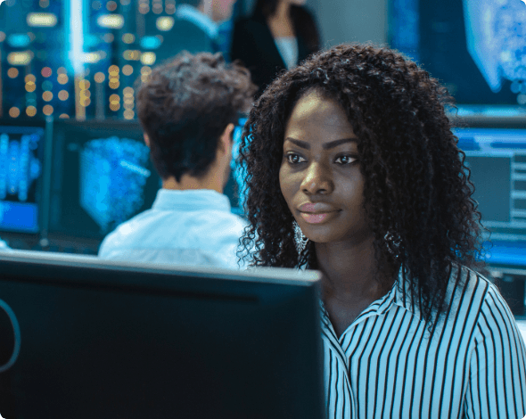 A cyber expert working in an office filled with computers.